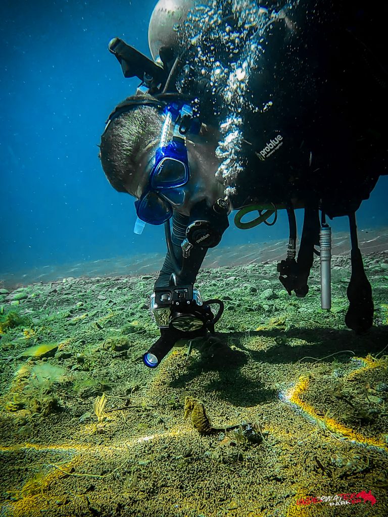 Rick Parker (Underwater Parker) filming a seahorse while scuba diving at Secret Corner in Dauin, Philippines.