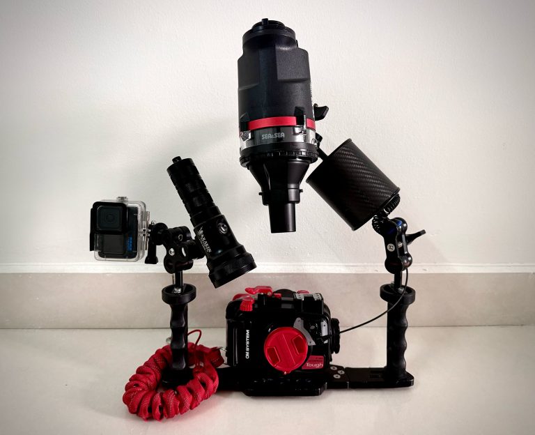Underwater camera rig with OM System TG-7, PT-059 housing, Sea&Sea strobe, Kraken video light, and float arm on tray kit handle system